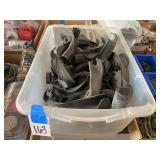 Clear Plastic Bin with Assorted Black Plastic Brackets and Parts