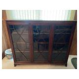 Three-Door Wooden Bookcase with Glass Panes and Shelving