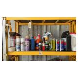 Shelf full of garage fluids and misc