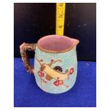 Majolica Pitcher has chip