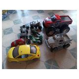 Assorted Toy Vehicles Including Cars, Trucks, and Military Toys