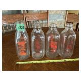 Four Embossed Glass Milk Bottles