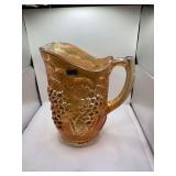 Imperial Marigold Carnival Glass Pitcher Featuring a Prominent Grape Design