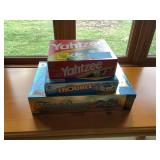 Trivial Pursuit 20th Anniversary, Yahtzee, and Pop-O-Matic Trouble Board Games