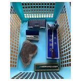 Assorted Items Including Viewfinder, Pen, Medical Device, and Petrified Wood