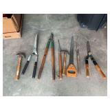 Assorted Hand Tools Including Saws, Hammers, and Cutting Tools