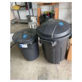 Two Black Plastic Trash Cans with Lids