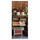 Assorted Household Items Including Decorative Boxes, Magazines, and Folding Chair