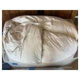 White Bedding Comforter in Plastic Storage Bin
