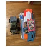 Assorted Toy and Game Lot Including Remote Control Truck, Foam Dart Blaster, and Marbles