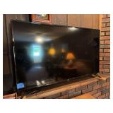 Onn Flat Screen Television and Box of Assorted VHS Tapes