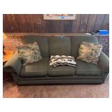 Three-Seat Sofa with Textured Green Upholstery and Decorative Pillows