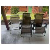 Lot of Three Outdoor Chairs Including Two Zero Gravity Lounge Chairs and One Metal Strap Chair