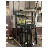 Metal Storage Rack with Contents Including Lawn Sprinklers, Garden Tools, and Folding Chairs