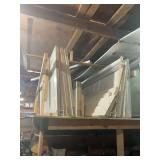 Assorted Building Materials Including White Paneled Doors Stored on Wooden Rack