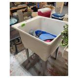 Freestanding Utility Sink with Miscellaneous Contents