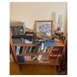 Assorted Estate Lot Featuring Books, Decorative Art, Linens, Tableware, and Small Furniture