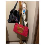 Wooden Coat Rack with Multiple Red Hooks and Assorted Tote Bags