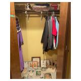 Closet Lot Containing Framed Art Prints, Clothing, and Shelf Decor