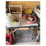 Folding Work Table with Assorted Contents Including Totes, Brushes, and Miscellaneous Supplies