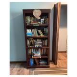 Dark Wood Laminate Bookcase Filled with Assorted Fiction and Non-Fiction Books