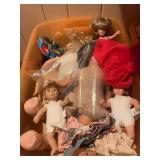 Mixed Lot of Dolls and Doll Clothing in Plastic Storage Bin