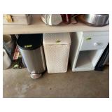 Lot of Three Household Items Including Stainless Steel Step Trash Can, Woven Hamper, and White Nightstand