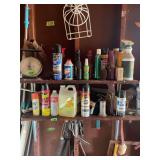 Assorted Household Cleaners, Sprays, and Automotive Fluids on Wooden Shelves