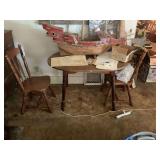 Wooden Model Ship Display on Table with Two Chairs