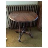 Round Wooden Parlor Table with Turned Legs and Casters