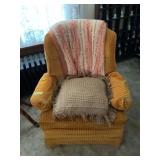 Gold Corduroy Upholstered Armchair with Decorative Pillows and Throw Blanket