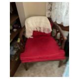 Red Upholstered Barrel Chair with Wooden Frame and White Throw Blanket
