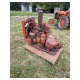 Red Four Cylinder Industrial Engine with Radiator Mounted on Wooden Base