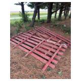 Red Painted Wooden Farm Gates and Lumber Stack