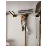 Assorted Yard and Garden Hand Tools Including Rakes and Saws