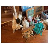 Assorted Doll Collection with Raggedy Ann, Porcelain Dolls, and Wicker Accessories