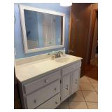 Bathroom Vanity with White Cabinet, Countertop, Sink, and Framed Mirror