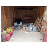 Shed Contents Assortment Including Tools, Gas Cans, Wood Planks, and Hardware