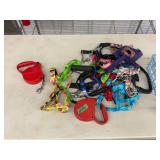 Assorted Pet Supplies Lot Featuring Retractable Leashes and Dog Harnesses