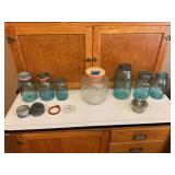 Assorted Collection of Glass Fruit Jars and Lids Including Atlas and Ball Brands