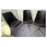 Three mid century vinyl swivel chairs