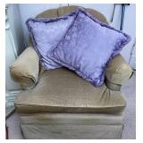 beige chair with purple pillows