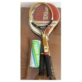 3 three tennis rackets with tennis balls