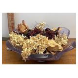 purple bowl with artificial flowers inside