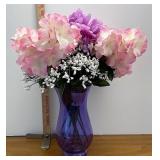 purple vase with artificial flowers