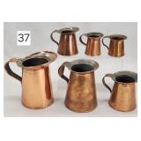 Primitive Copper Graduated Measuring Pitchers
