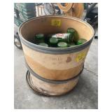 CARDBOARD BARREL FULL OF 7UP GLASS BOTTLES