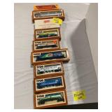 ROW OF TYCO BOXED TRAIN CARS