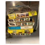 STACK OF PLASTIC TRAIN MODEL BUILDING KITS -