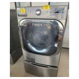 GREY LG WASHING MACHINE ON STORAGE DRAWER BASE
